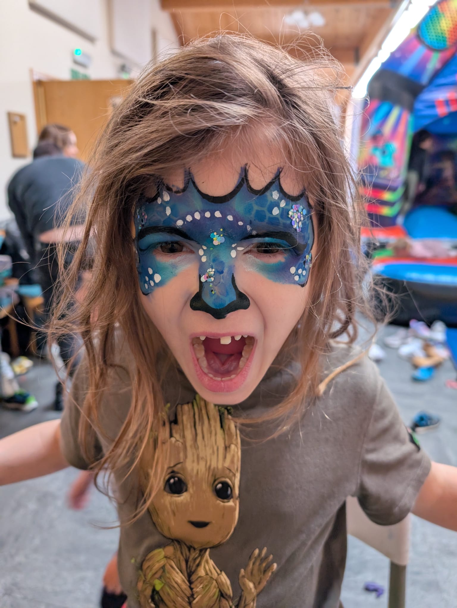 Blue dragon monster face paint for a boy