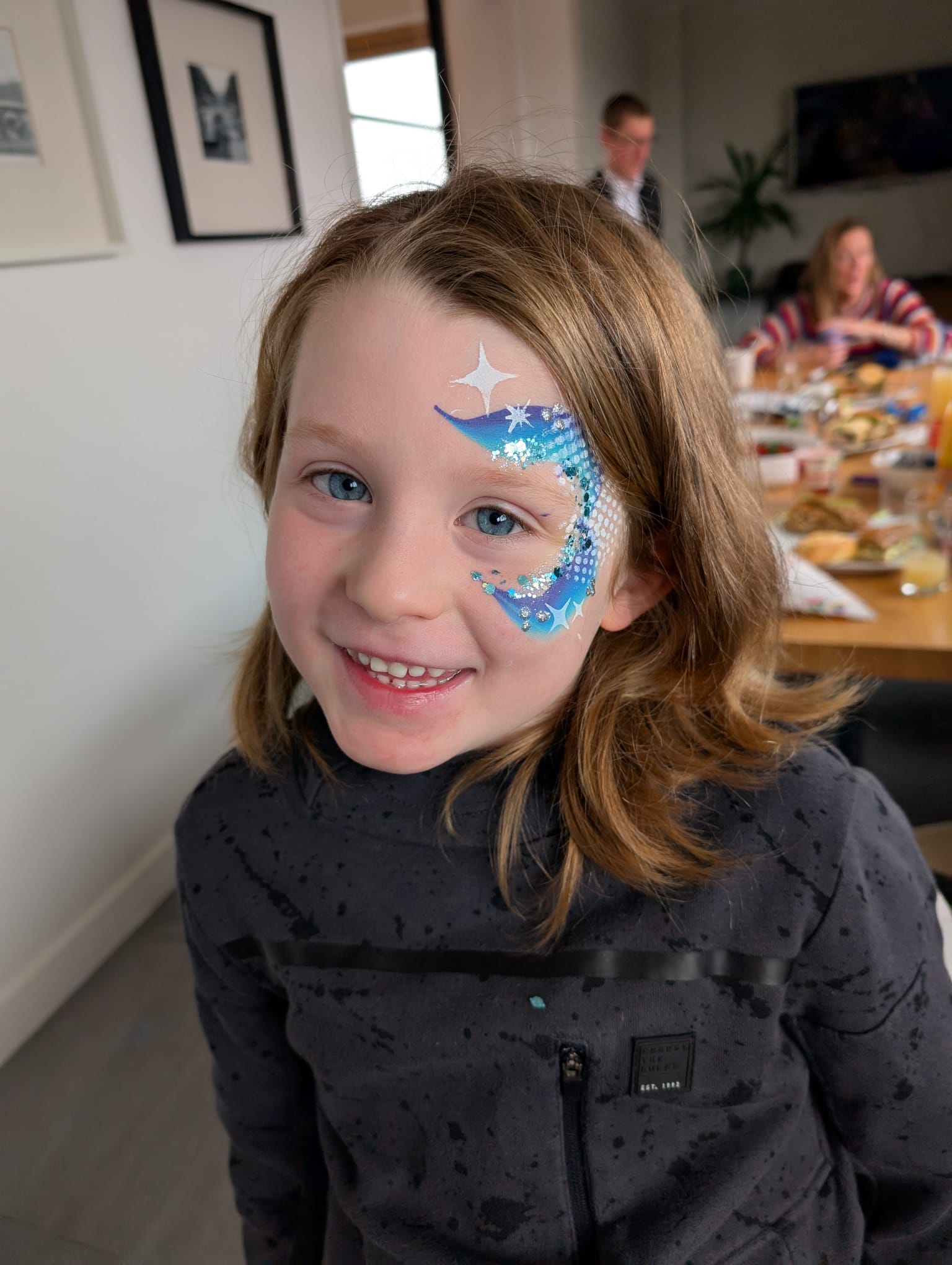 Blue shooting stars face paint for a girl