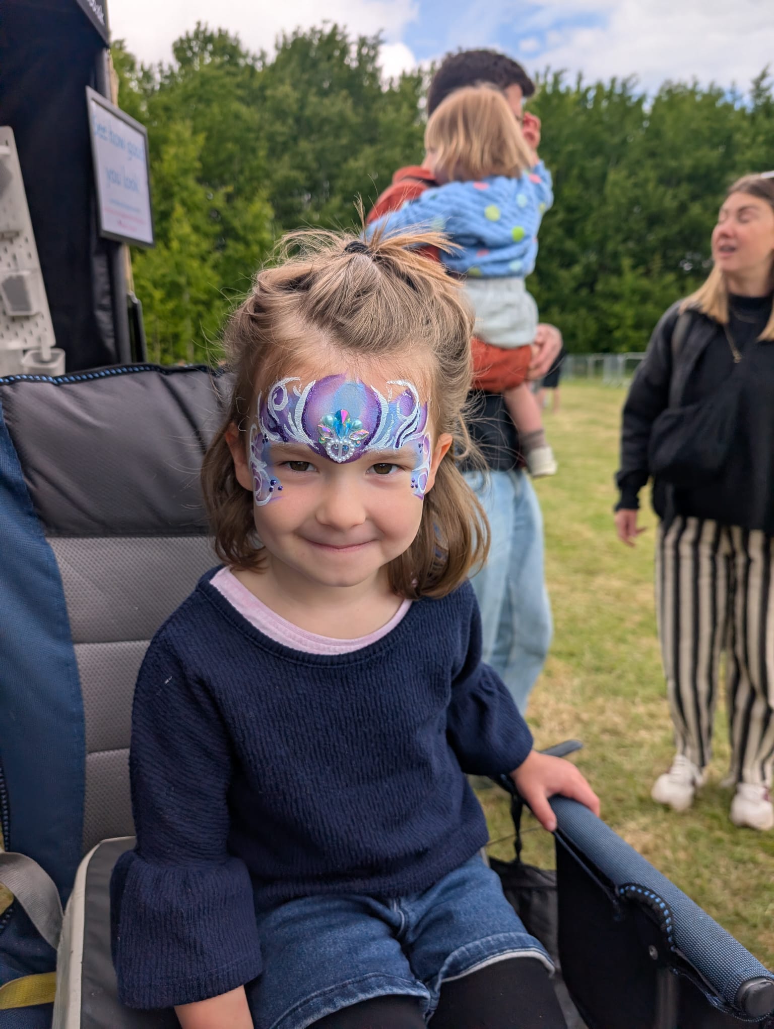 Blue snowflake crown face paint for a girl