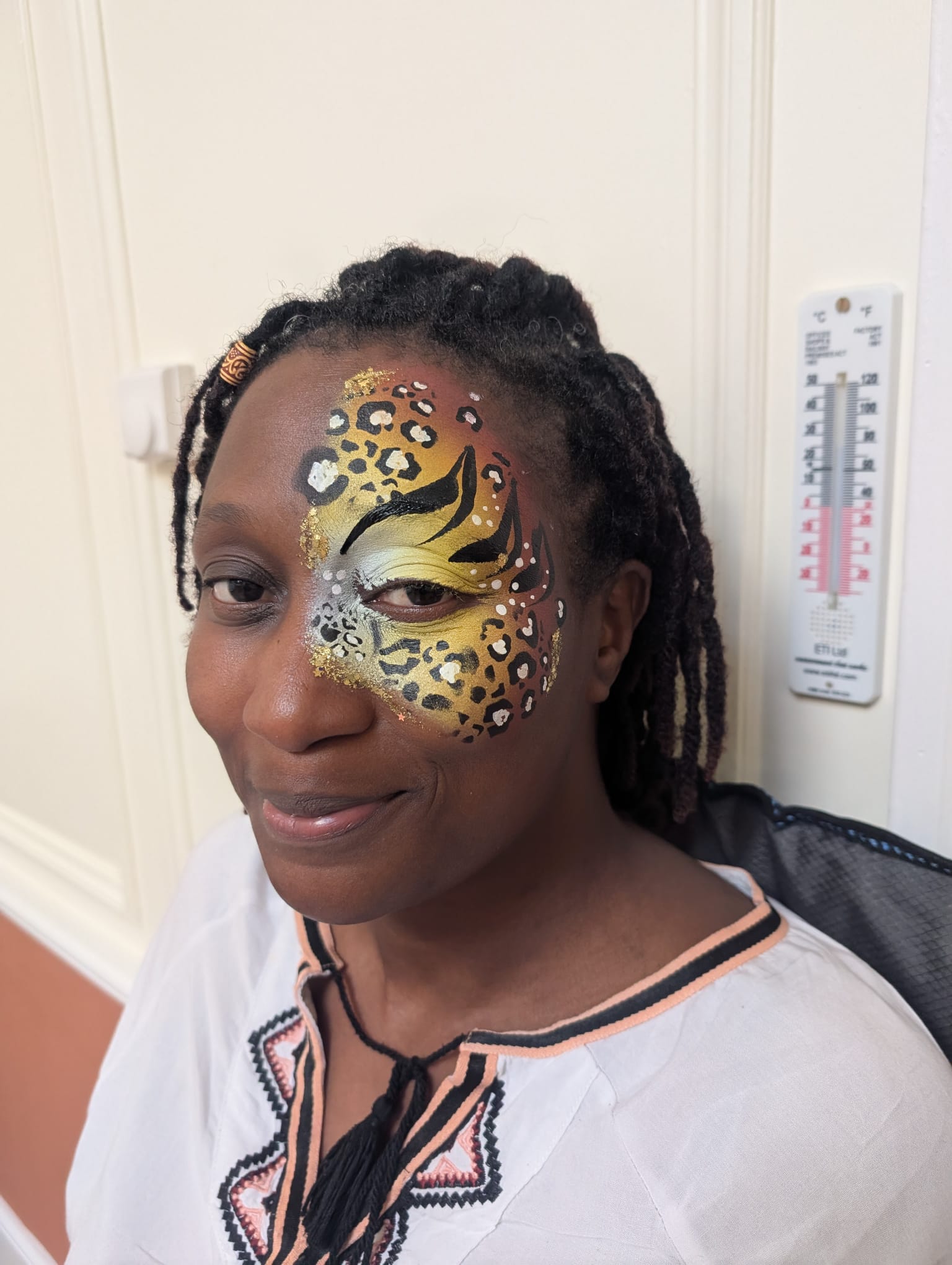 Gold leopard print half-face paint for a woman