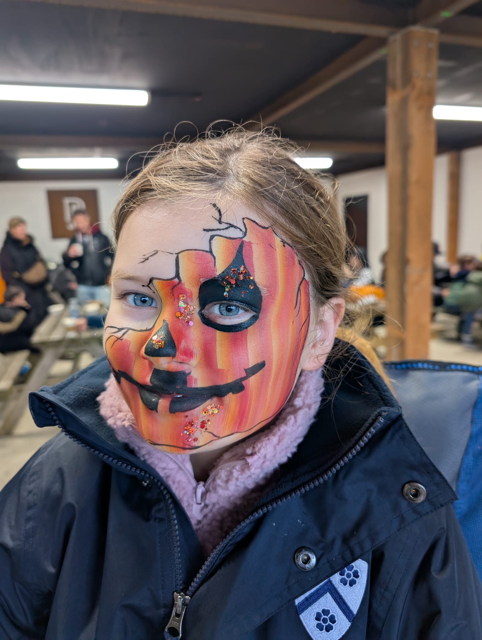 Jack-o-lantern pumpkin face paint for a girl