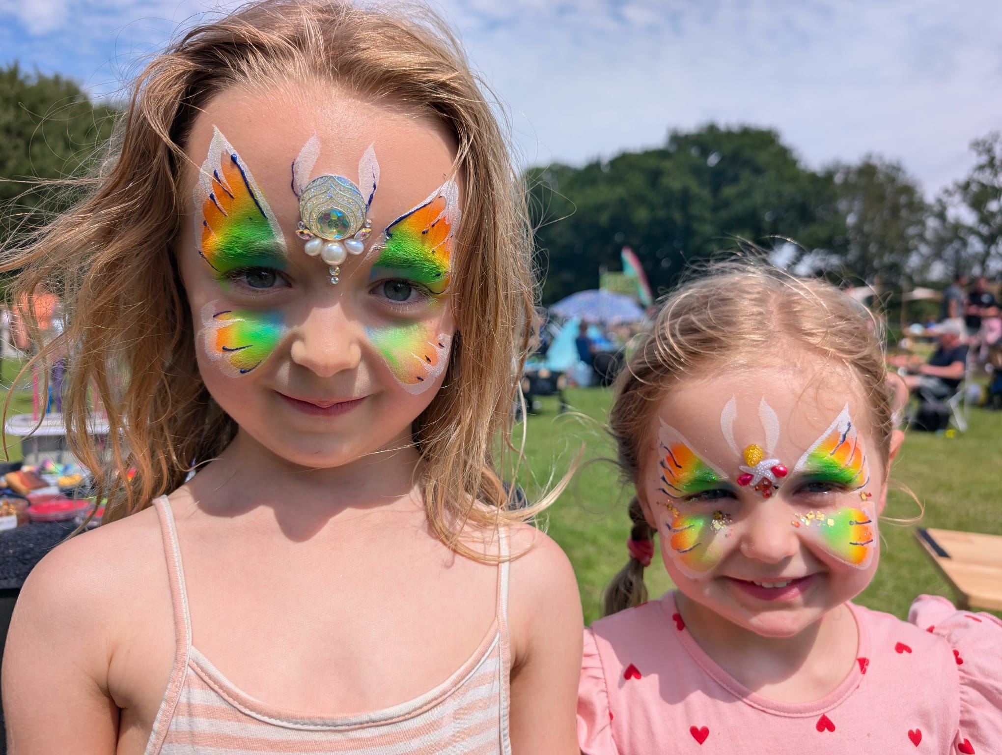 Rainbow butterfly face paint for sisters