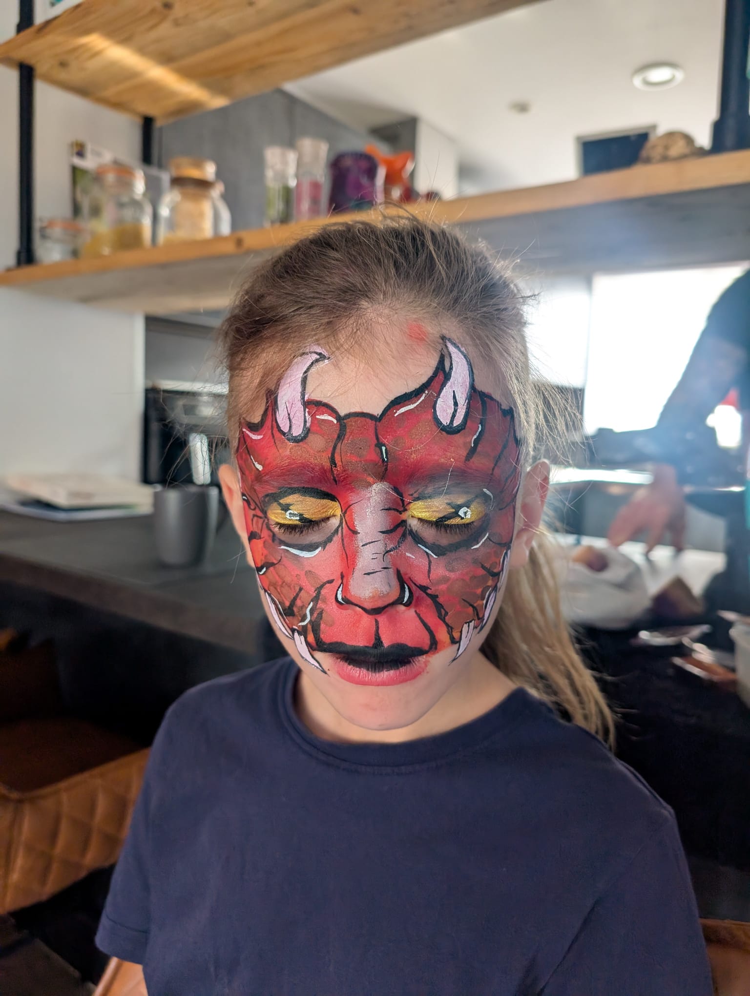 Red devil face paint for a girl